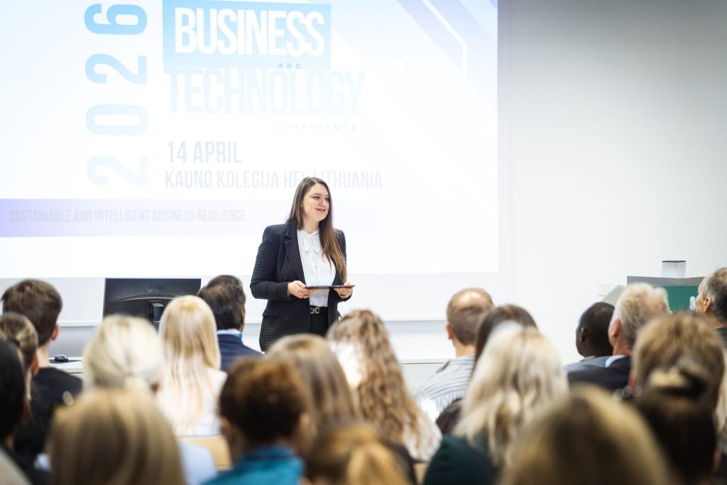 Speaker presenting at the Business and Technology 2026 conference at Kauno kolegija in front of an audience