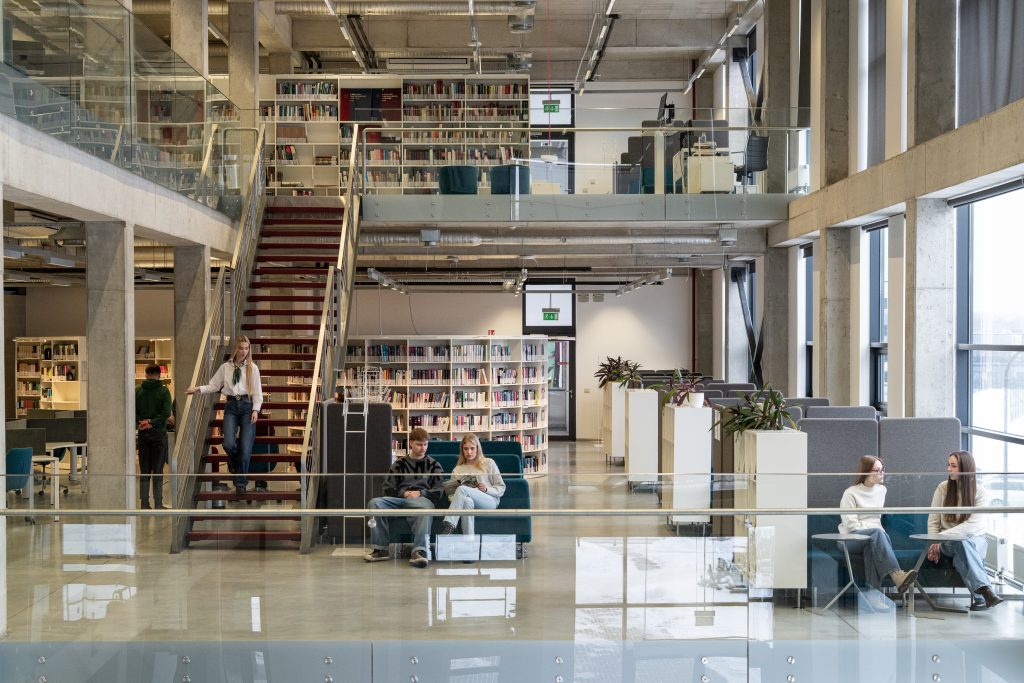 Students studying and collaborating in the modern, multi-level library and learning centre at Kauno kolegija Higher Education Institution.
